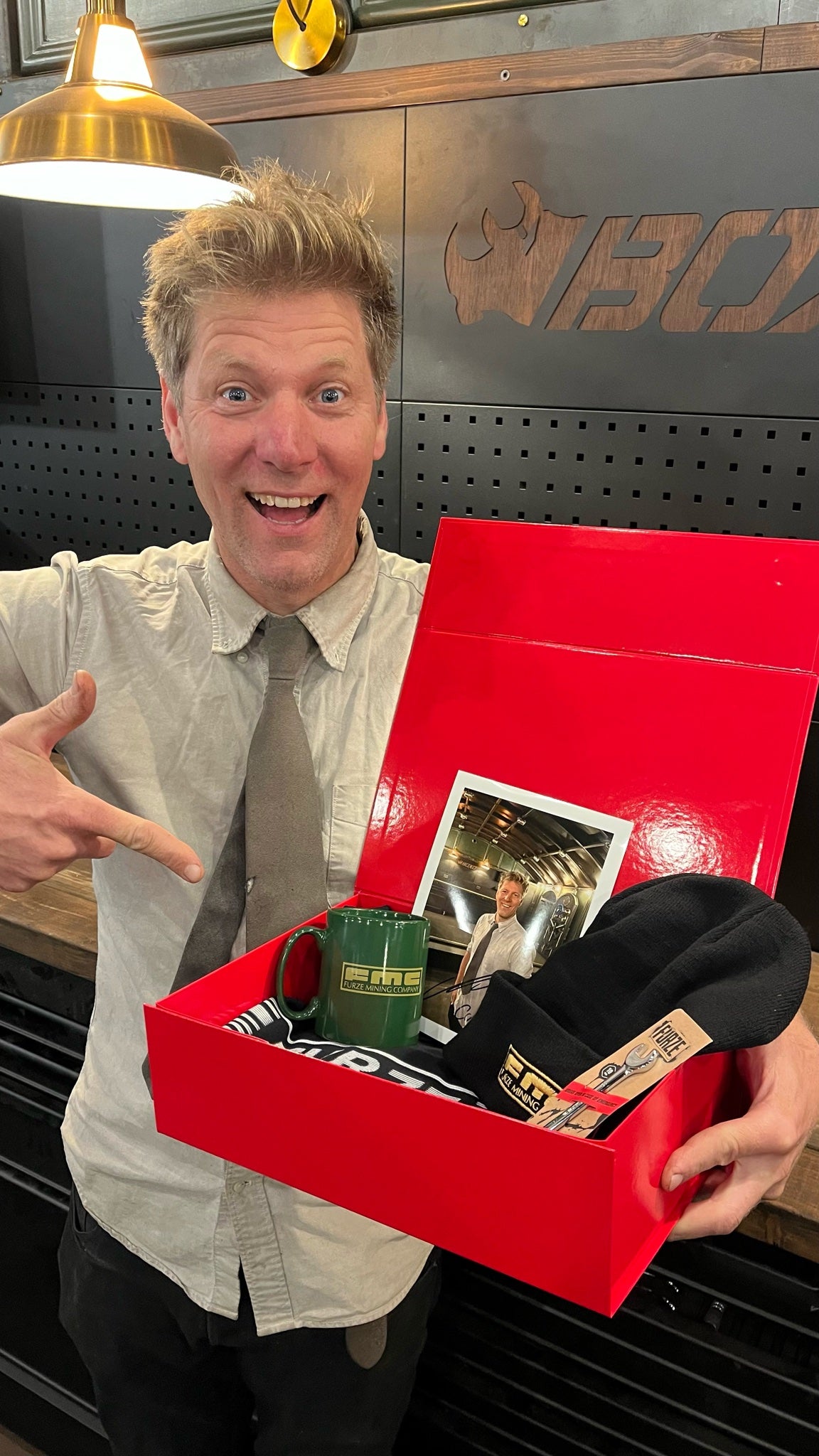 Colin Furze pointing excitedly at the open FMC Bundle box in his workshop