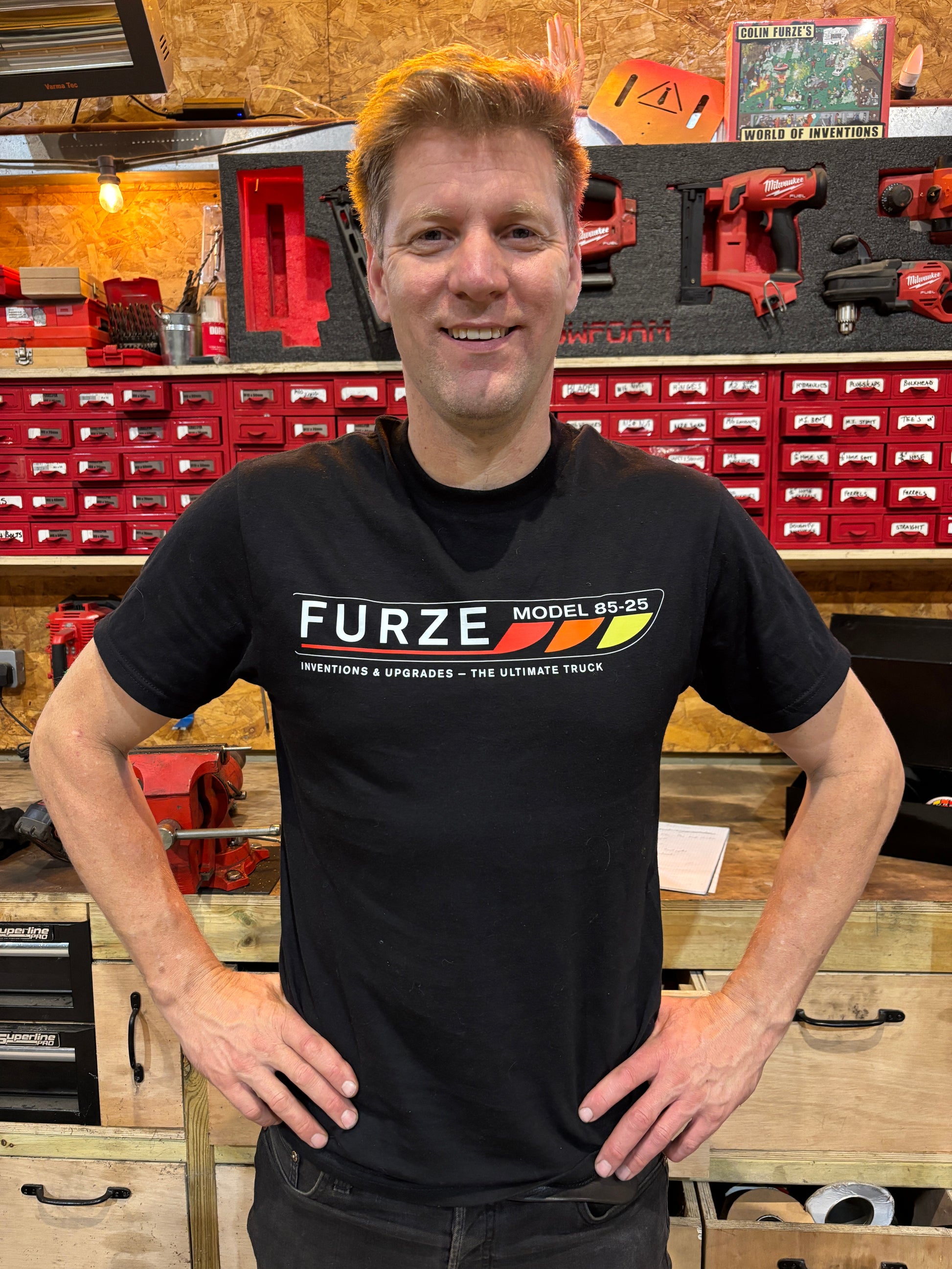 Colin wearing a black t-shirt with 'FURZE' branding in his workshop 