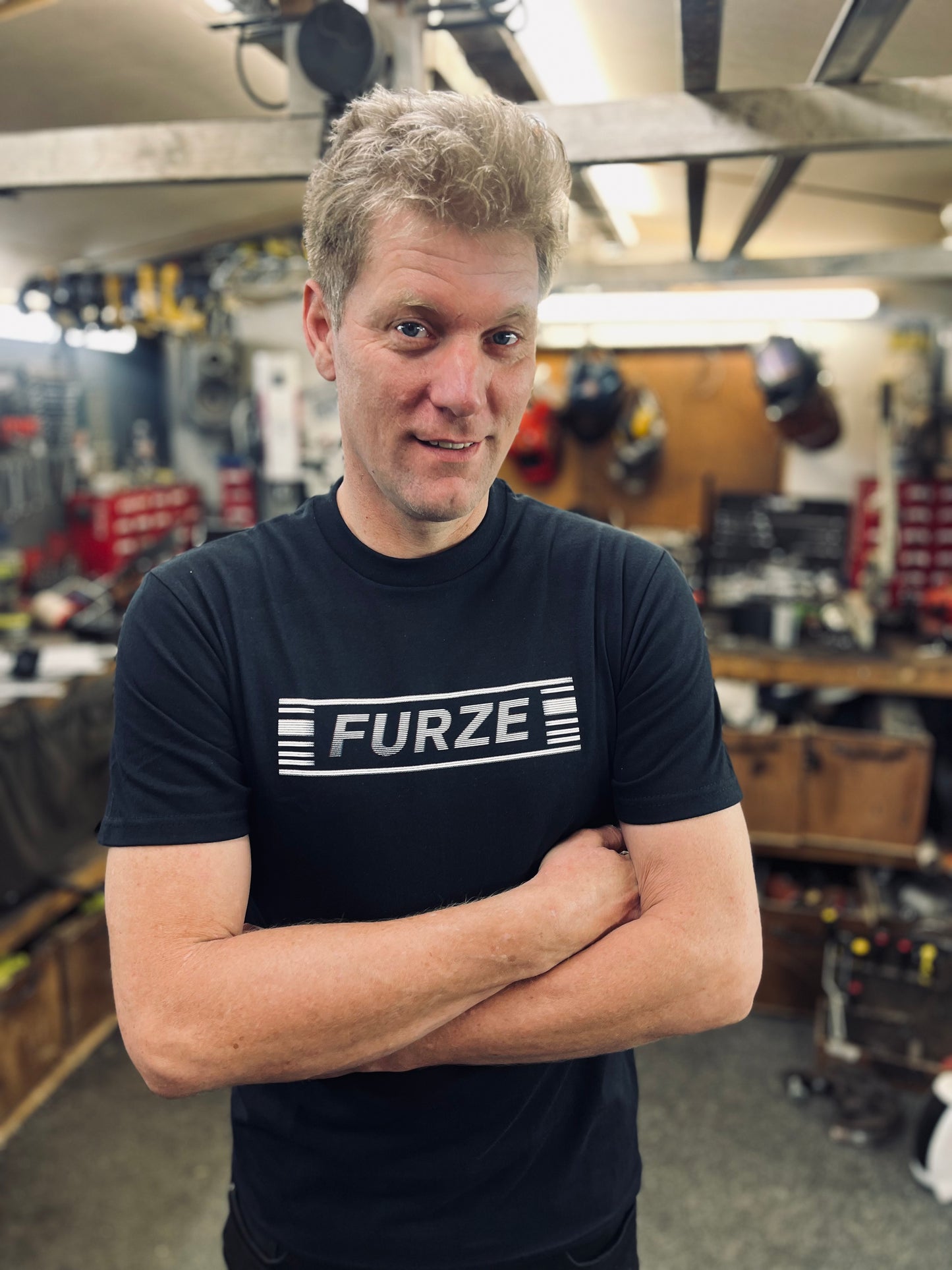 Colin wearing a black 'FURZE' t-shirt in his workshop
